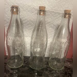 3 antique coca-cola bottles with cork